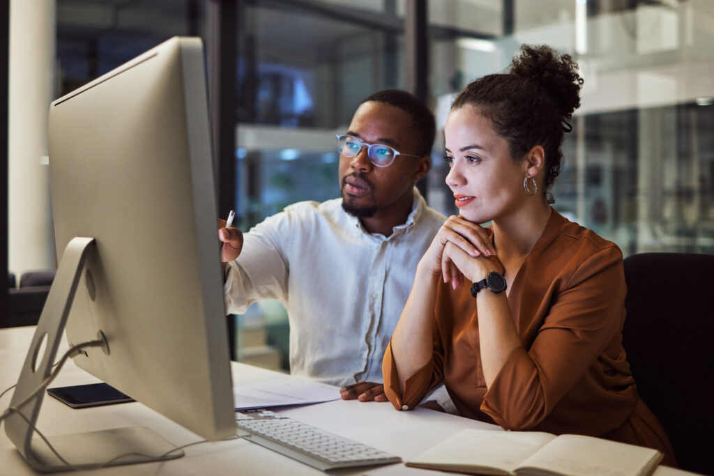 two business people looking at screen